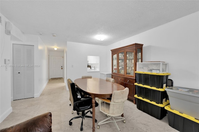 dining room with a textured ceiling