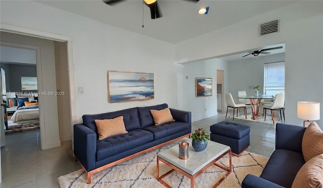 living room with tile patterned floors and ceiling fan