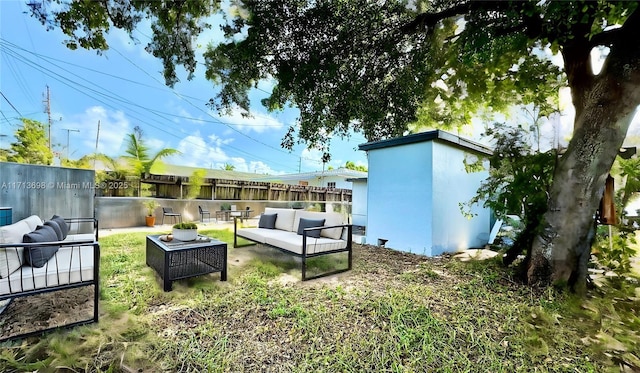 view of yard featuring an outdoor living space and a storage unit