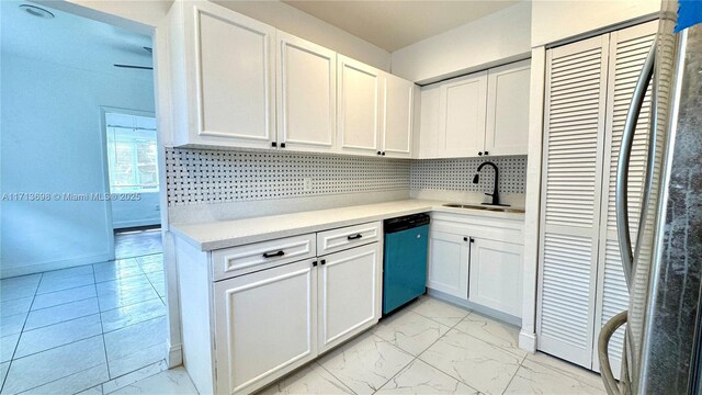 kitchen with stainless steel appliances, sink, decorative backsplash, and white cabinets