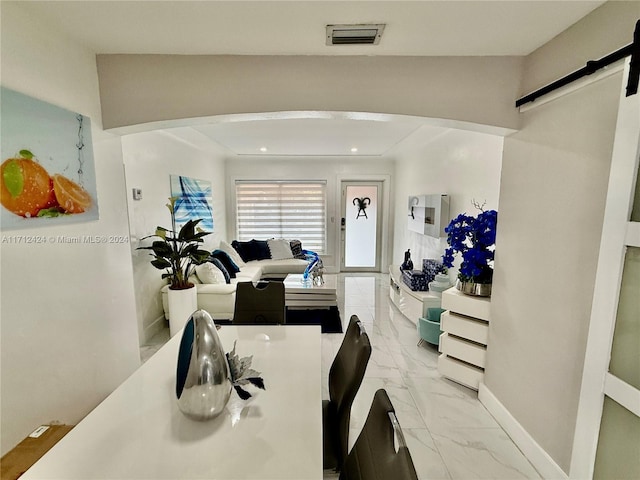 dining space featuring a barn door