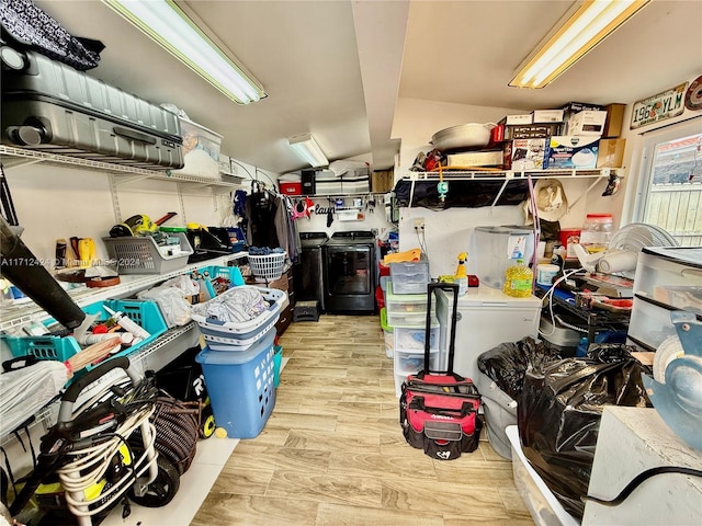 storage area with washing machine and clothes dryer