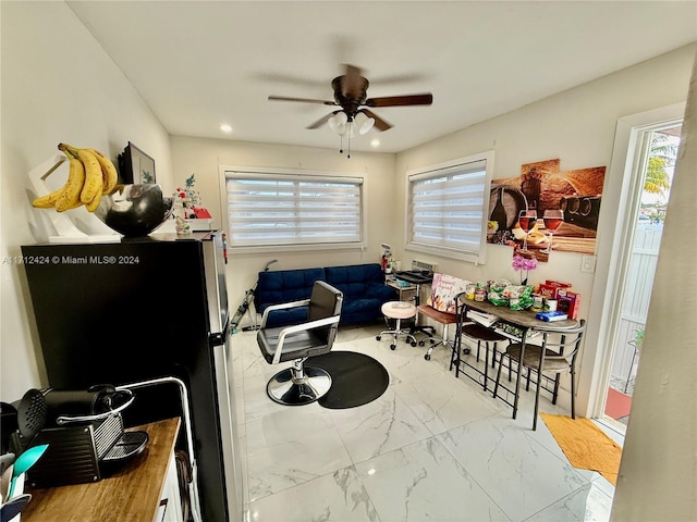 interior space with stainless steel fridge and ceiling fan