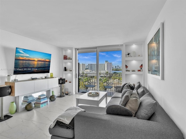 living room featuring built in features and a wall of windows