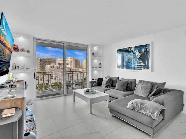 living room with built in shelves and floor to ceiling windows