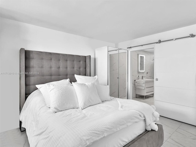 bedroom with a barn door and ensuite bathroom