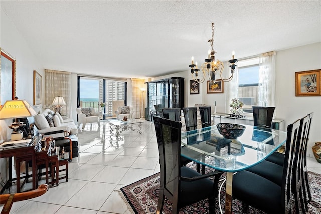 dining area featuring a textured ceiling, floor to ceiling windows, a notable chandelier, and light tile patterned flooring