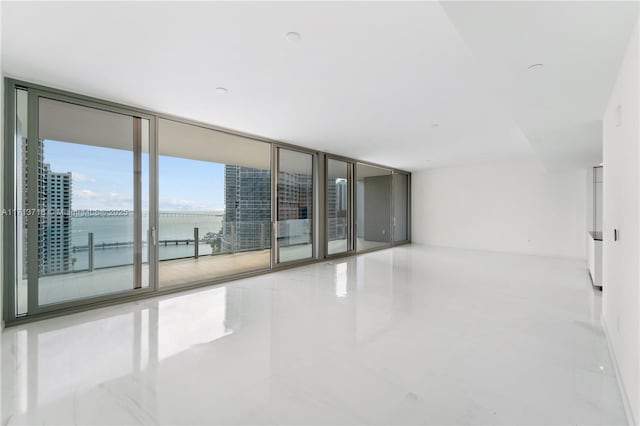 empty room with expansive windows and a water view