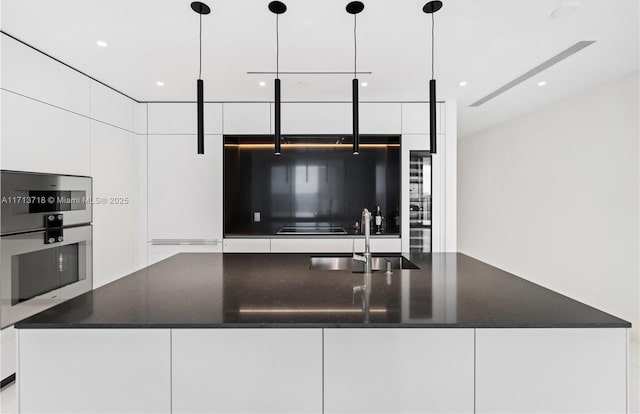 kitchen with modern cabinets, white cabinets, and a sink