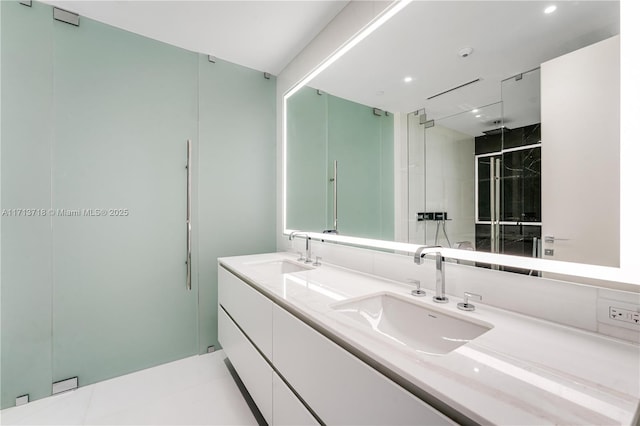 full bath featuring double vanity, a stall shower, and a sink