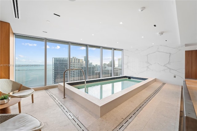 view of pool featuring a view of city and a hot tub