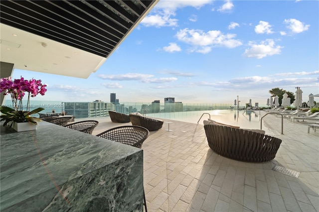 view of patio featuring a view of city and outdoor dining area