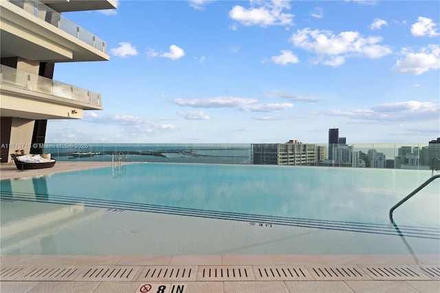 view of swimming pool with a city view