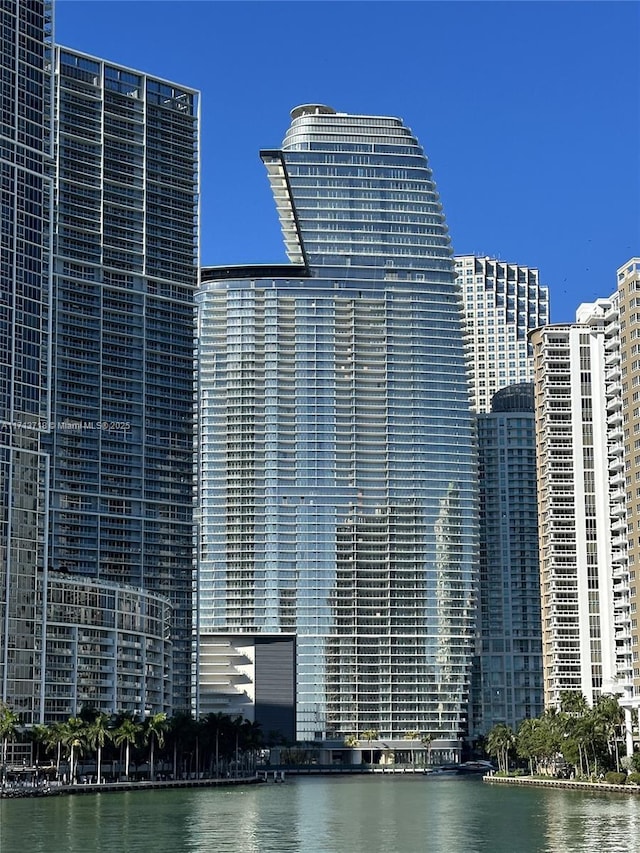 view of building exterior with a water view and a city view