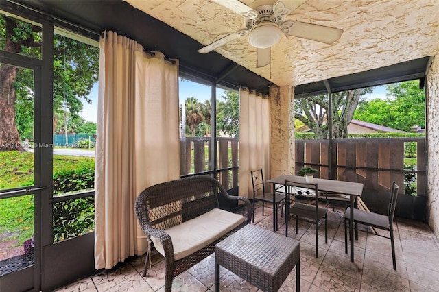 sunroom featuring ceiling fan