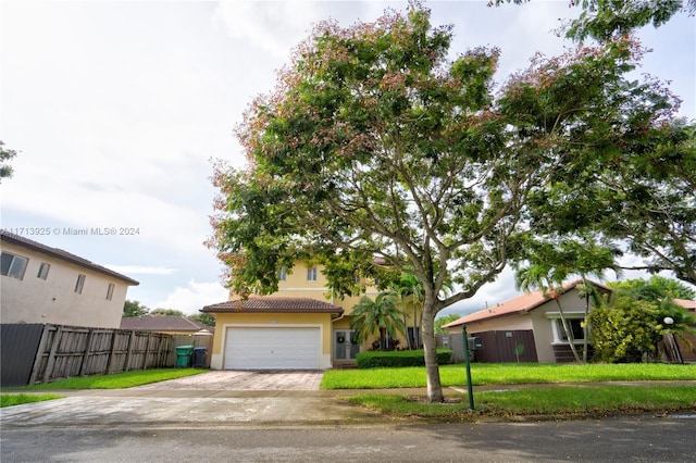 view of front of property with a front lawn and a garage