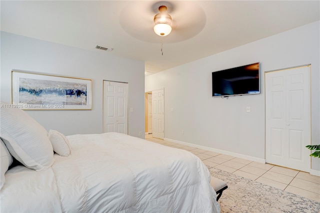 tiled bedroom featuring ceiling fan