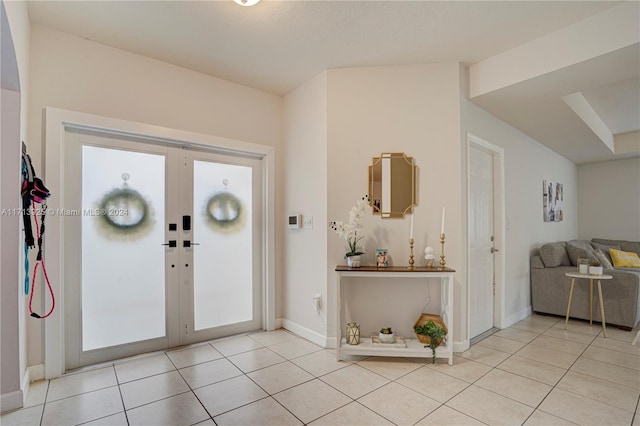 foyer featuring light tile patterned floors and french doors