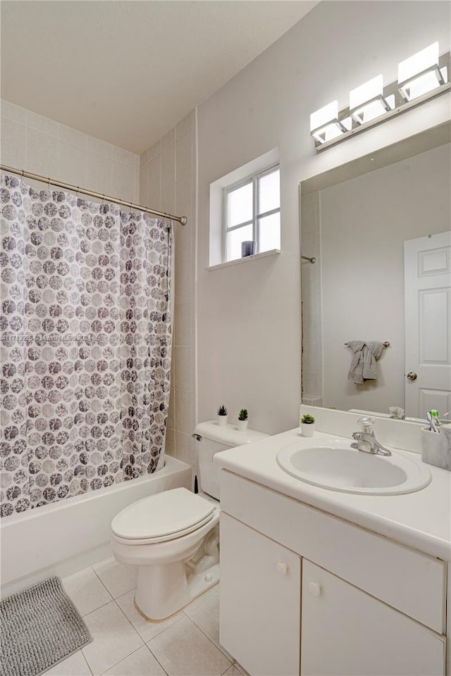 full bathroom featuring tile patterned floors, vanity, toilet, and shower / bath combo