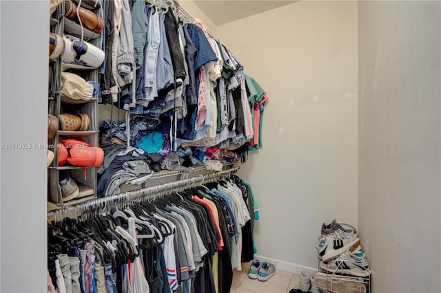 walk in closet with light tile patterned floors