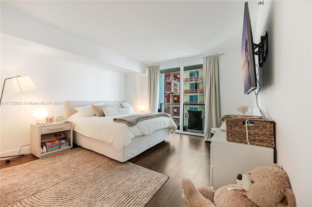 bedroom with dark hardwood / wood-style flooring and expansive windows