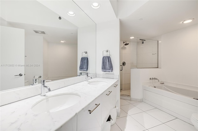 bathroom with tile patterned flooring, vanity, and plus walk in shower