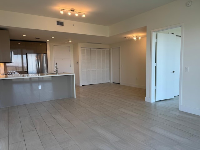 kitchen featuring sink and stainless steel refrigerator