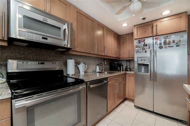 kitchen featuring sink, decorative backsplash, ceiling fan, light tile patterned floors, and stainless steel appliances