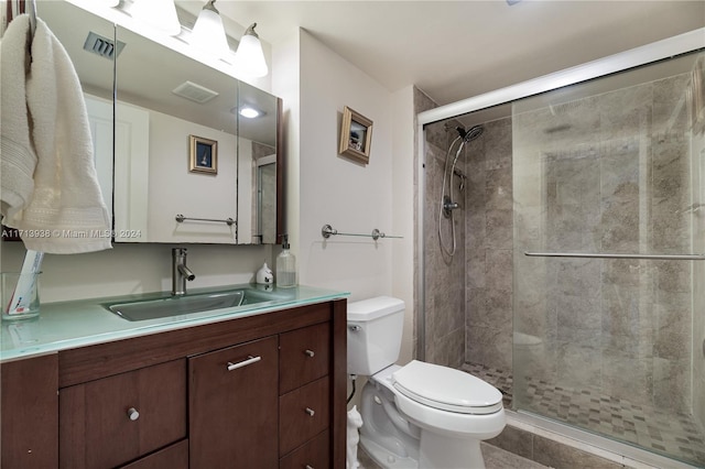 bathroom featuring walk in shower, vanity, and toilet