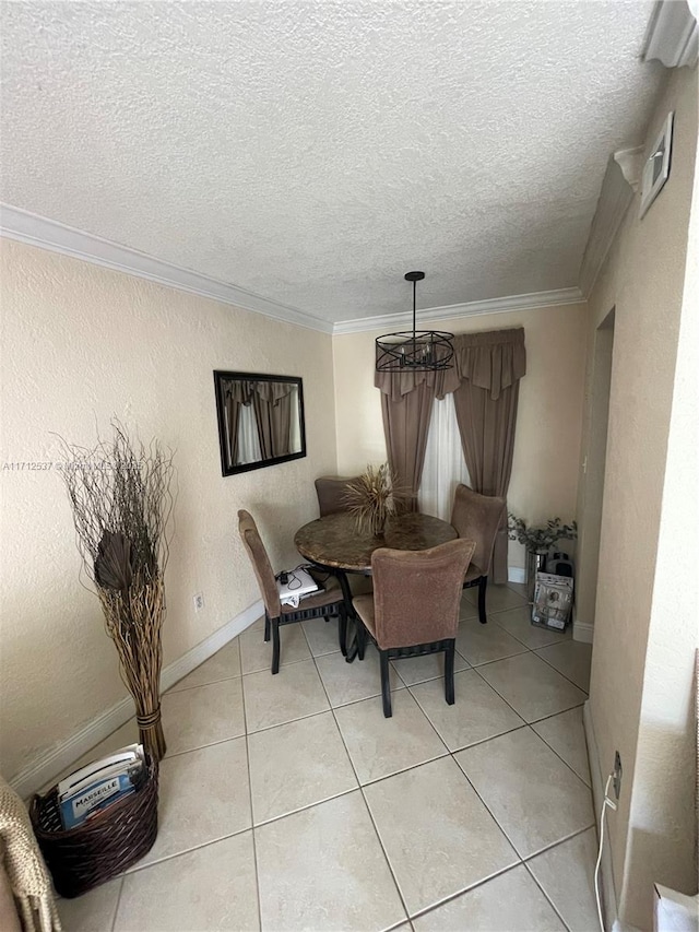 dining room with light tile patterned floors, ornamental molding, a chandelier, and a textured ceiling