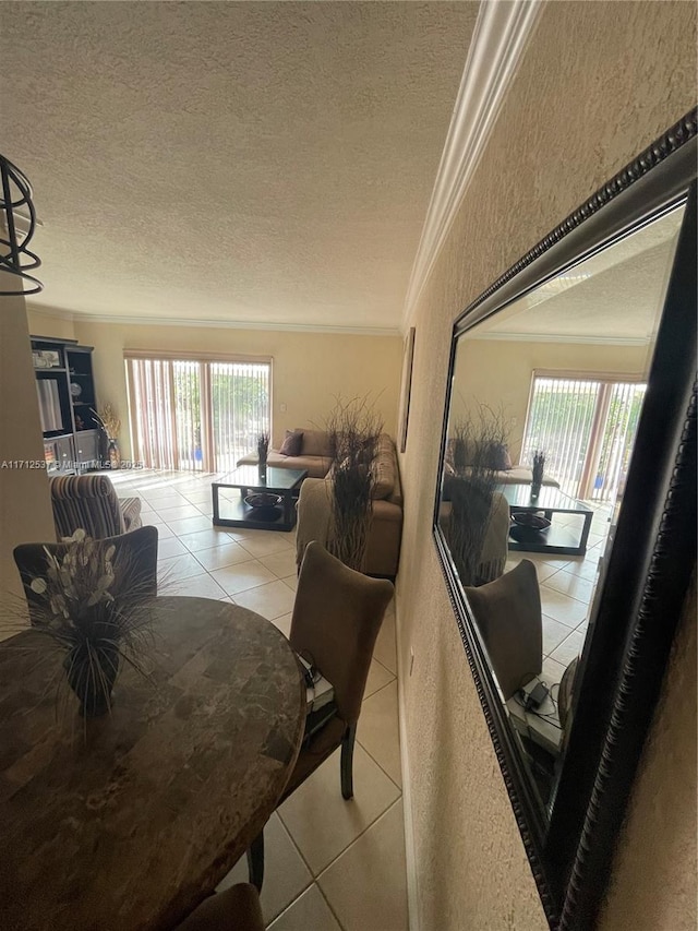 dining area featuring crown molding, a textured ceiling, a healthy amount of sunlight, and tile patterned floors