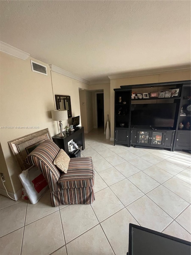 living room with light tile patterned flooring, ornamental molding, and a textured ceiling