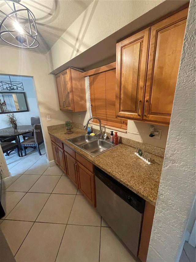 kitchen featuring light tile patterned flooring, dishwasher, and sink