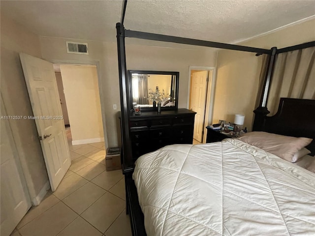 tiled bedroom featuring a textured ceiling