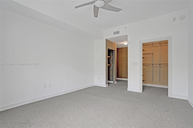 unfurnished bedroom with carpet flooring, ceiling fan, and a closet