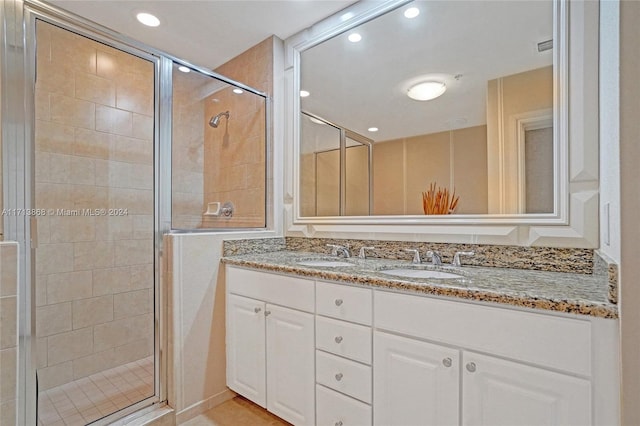 bathroom with vanity and a shower with shower door