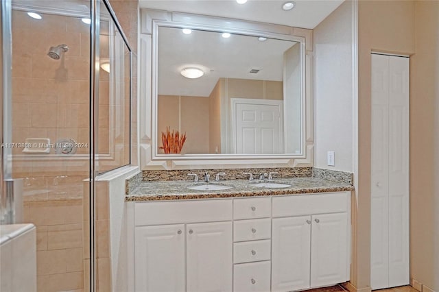 bathroom featuring vanity and an enclosed shower