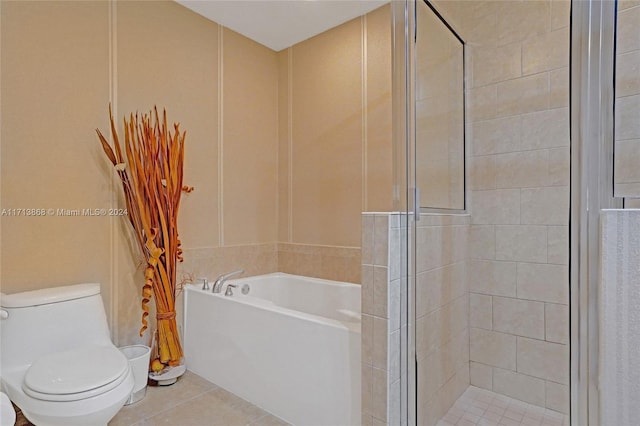 bathroom with tile patterned floors, toilet, and independent shower and bath