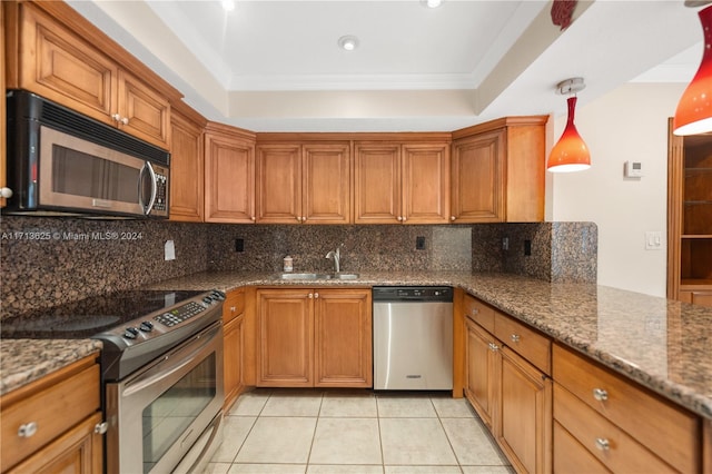 1709 Saint Andrews Rd, Hollywood, FL 33021 - kitchen with appliances with stainless steel finishes, brown cabinetry, decorative backsplash, light tile patterned flooring, and recessed lighting