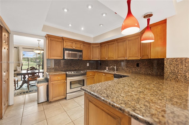 1709 Saint Andrews Rd, Hollywood, FL 33021 - kitchen with stainless steel appliances, a raised ceiling, decorative backsplash, brown cabinets, and stone countertops