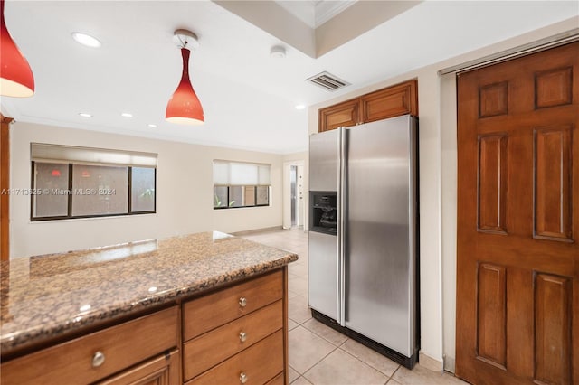 kitchen featuring hanging light fixtures, stainless steel fridge with ice dispenser, light stone counters, crown molding, and light tile patterned floors