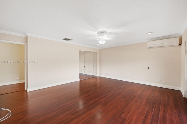 empty room with ornamental molding, a wall unit AC, ceiling fan, and dark wood-type flooring