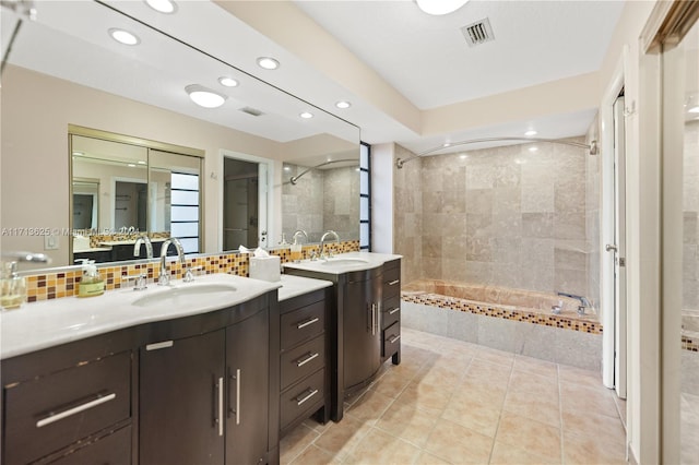 bathroom featuring tile patterned floors, vanity, and decorative backsplash