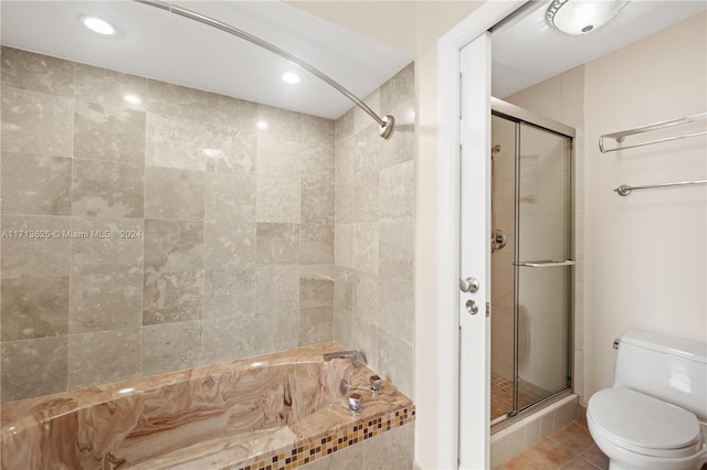 bathroom with tile patterned flooring, shower with separate bathtub, and toilet