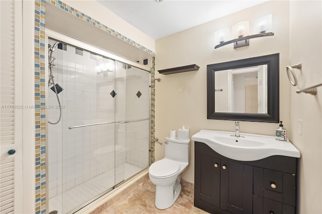 bathroom with vanity, an enclosed shower, and toilet