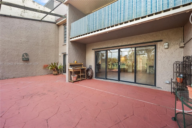 view of patio with glass enclosure