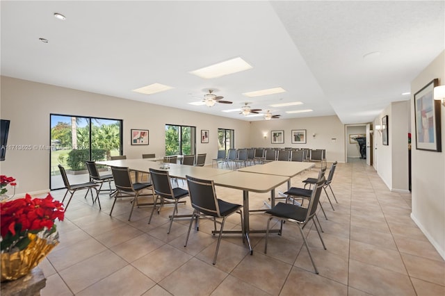 tiled dining space featuring ceiling fan