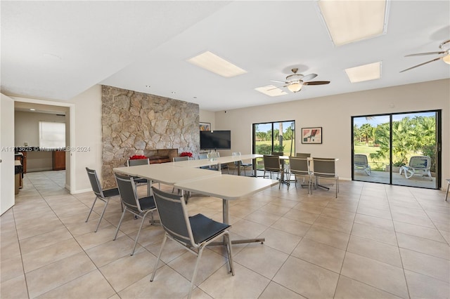 kitchen with a breakfast bar, light tile patterned floors, and ceiling fan