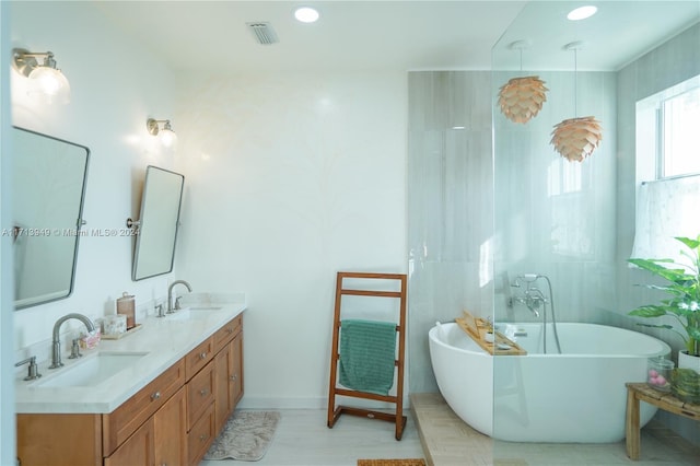 bathroom featuring a washtub and vanity