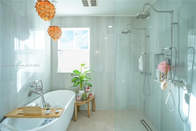 bathroom featuring separate shower and tub